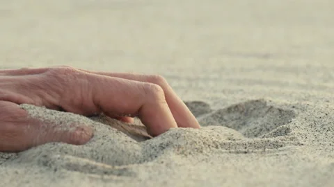 Close up of a hand touching the sand Stock Footage 172538738