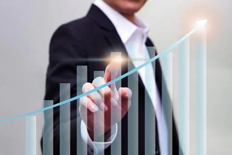 Close up of hand touching on virtual glowing business chart hologram on blu.. Stock Photos