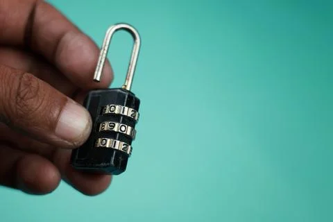 Close up hand try open black padlock with password Photos