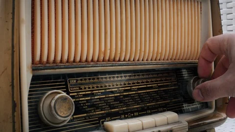Close up Hand tuning radio button on vintage radio Stock Footage 129112427