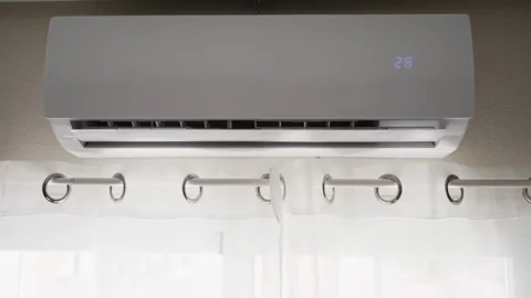 Close-up of hand turning on air conditioner with remote control, illustrati.. Stock Footage 342441426
