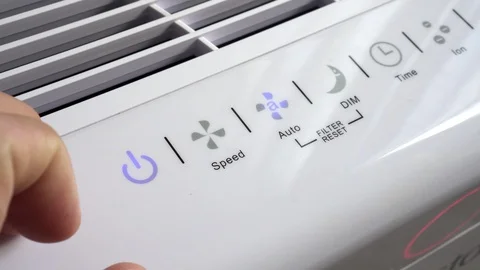 Close up of hand turning ON air filter. Portable air purifier for allergies. Stock Footage 129137245