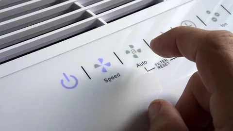 Close up of hand turning ON air filter. Portable air purifier for allergies. Stock Footage 129137309