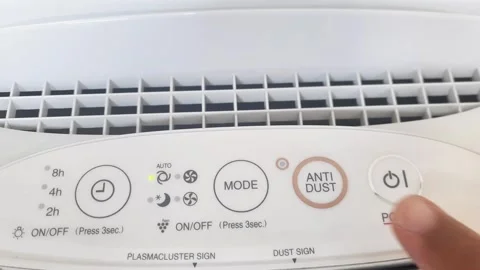 Close up of hand turning ON air filter. Portable air purifier for allergies. Video stock 289200951