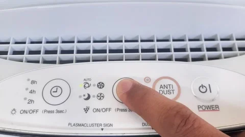 Close up of hand turning ON air filter. Portable air purifier for allergies. Stock Footage 289200971