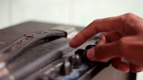 Close Up Of Hand Turning The Amplifier Knob. Stock Footage 257155275