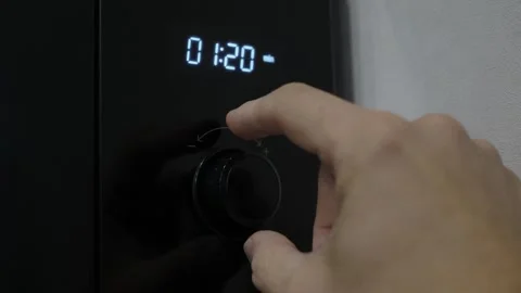 Close-up hand turning black appliance control knob Stock-Footage 342864178