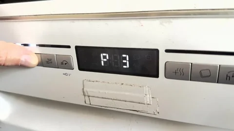 Close up of hand turning control knob on kitchen stove, adjusting heat level, Stockbeeldmateriaal 337104537
