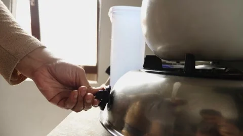 Close up of hand turning on fire on stove, ready to cook Stock Footage 280733072
