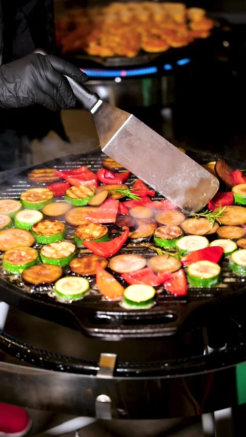 Close Up of Hand Turning Grilled Vegetables on BBQ at Dinner Time Stock Footage 315863090