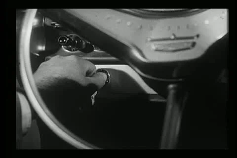 Close-up of hand turning ignition key in 1960s car 스톡 동영상 11353692