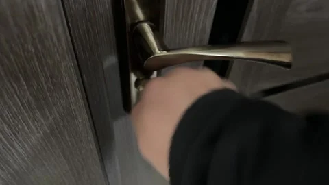 Close up of hand turning key in door lock, unlocking mechanism and gaining Stock Footage 337110398