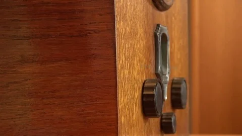 Close up of hand turning knobs on very old radio 스톡 동영상 76841902