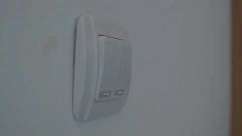 Close up of a hand turning a light switch on and off Stock Footage 339196647