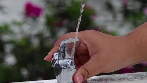 Close Up of Hand Turning Off Outdoor Drinking Water Fountain Stock Footage 328139141