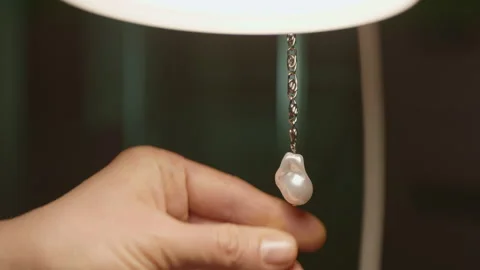 Close-up of a hand turning on a table lamp. Lighting in a dark interior. Stock Footage 230524963