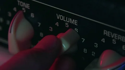 Close up of Hand Turning Volume Button up of Amplifier Stock Footage 123858195