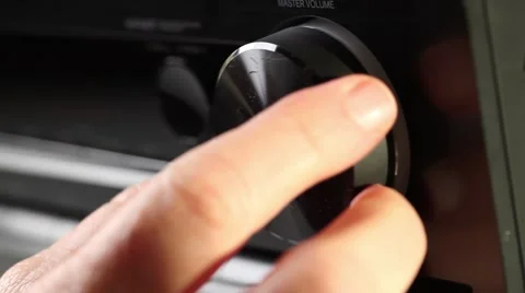 Close up of hand turning a volume knob on home stereo unit Stock Footage 52817017