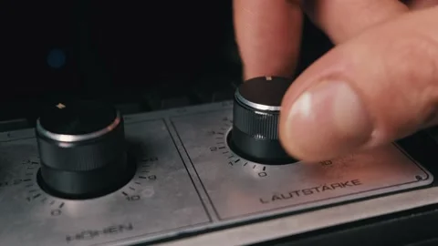 Close Up of Hand Turning Volume Knob on Vintage Stereo Amplifier Stock Footage 334110876