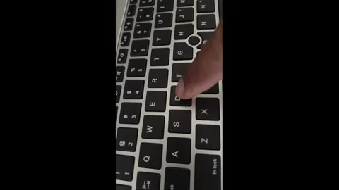 Close-up of hand typing on backlit laptop keyboard. Stock Footage 340000329