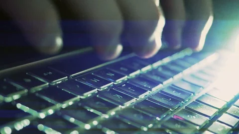 Close Up of a hand typing on a computer laptop on the keyboard at night in th Stock Footage 124703982