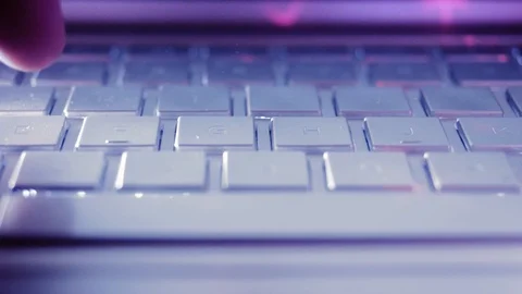 Close Up of a hand typing on a computer laptop on the keyboard at night in th Stock Footage 124704006