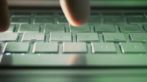 Close Up of a hand typing on a computer laptop on the keyboard at night in th Stock-Footage 124704042