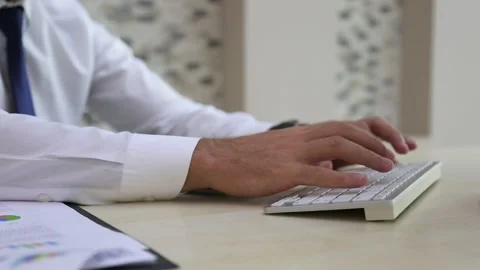 Close Up Hand Typing on Keyboard with Charts Stock Footage 346181713