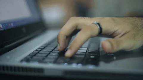 Close up of hand typing on keyboard of laptop from side view Stock Footage 248856466