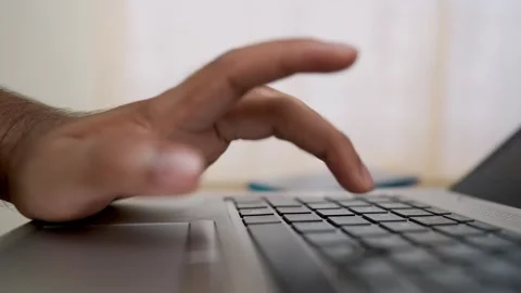 Close-up of a hand typing on a laptop keyboard Stock Footage 315983099