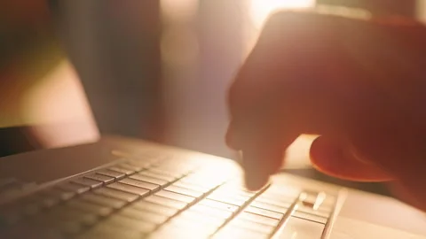 Close Up of Hand Typing on Laptop Keyboard in Warm Sunset Backlight, Digital Wor Stock Footage 329041976