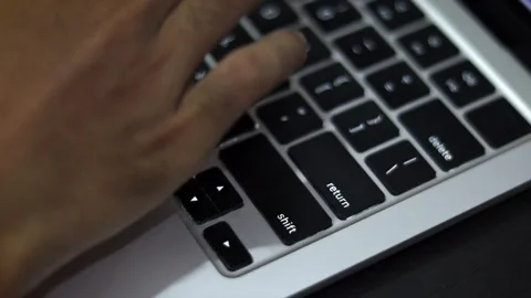 Close Up of Hand Typing on Laptop Keyboard in Modern Workspace Vídeo Stock 340450443