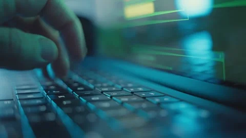 Close up on hand typing on laptop keyboard coding or hacking into server Stock Footage 341875568