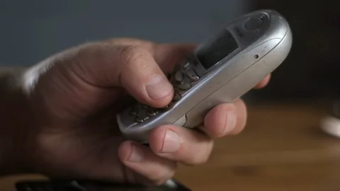 Close-up of hand typing phone number with fingers on keyboard of old, cell phone 스톡 동영상 128095312