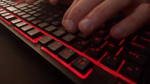 Close Up of Hand Typing on Red LED Keyboard Vídeos de archivo 329137790