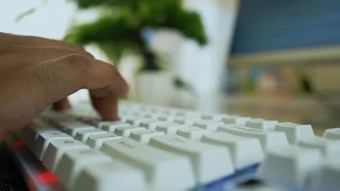 Close-up of a hand typing on a white keyboard with a blurred background Stock Footage 317737183