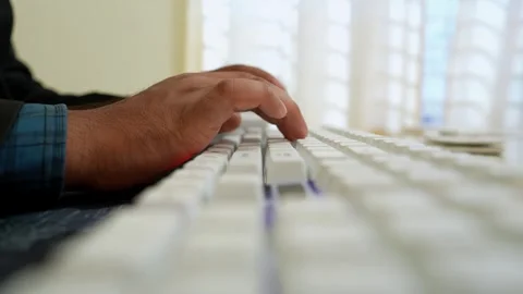 Close-Up of Hand Typing on White Keyboard Stock Footage 318578221