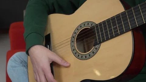 Close up on hand of unknown caucasian man hold and play guitar Stock Footage 242769683