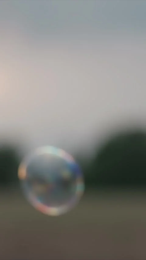 Close Up of Hand Unscrewing Bubble Solution Container Outdoors featuring fingers Stock Footage 348316503