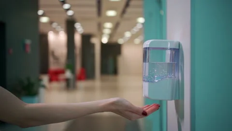 Close up hand use automatic sanitizer with antiseptic for prevention covid 19 Stock Footage 138654312