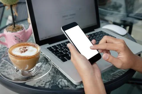Close up hand use phone in coffee shop Stock Photos