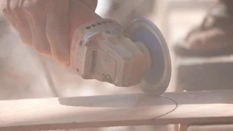 Close-up of a hand using an angle grinder to cut metal, sparks blurred in warm l Stock-Footage 333330475