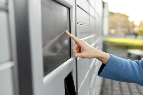 Close up of hand using automated parcel machine Stock Photos