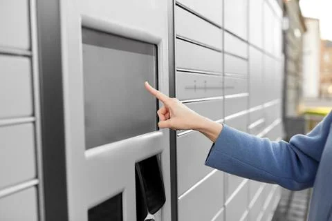 Close up of hand using automated parcel machine 스톡 사진