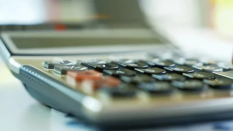 Close-Up of Hand Using Calculator, Close-up of a hand pressing buttons on a.. Stock Footage 321223898