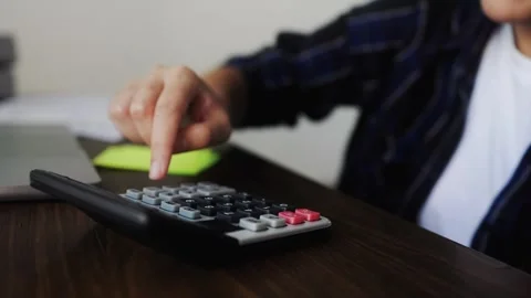 Close-up of hand using calculator on desk Finance, savings and economic crisis Stock Footage 324606008