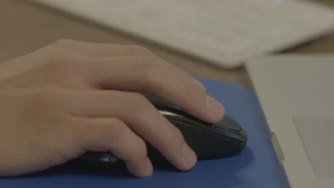 Close up of hand using a computer mouse Stock Footage 134580322