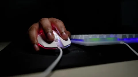 Close-up of a hand using a computer mouse with a keyboard in the background Stock Footage 317737392