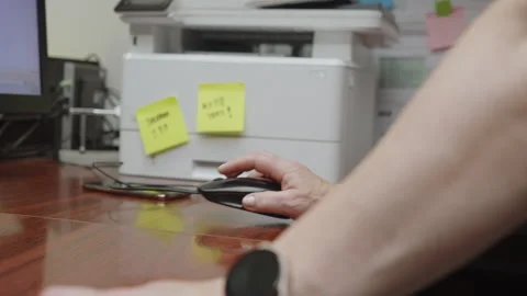 Close Up of Hand Using Computer Mouse on Office Desk with Printer Background 4K Stock Footage 338423577