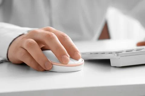 Close-up of hand using computer mouse with keyboard Stock Photos